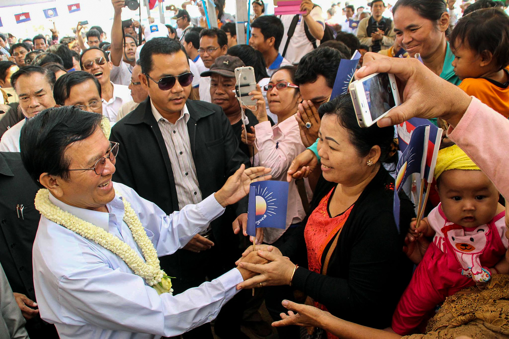 Deputy opposition leader Kem Sokha greets supporters at a public forum in Phnom Penh's Sen Sok district Sunday.