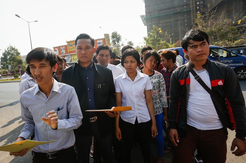 Srey Chamroeun, left, stands with a group of students outside the National Assembly in Phnom Penh, where they delivered a petition on Monday calling for deputy opposition leader Kem Sokha to be questioned. (Siv Channa/The Cambodia Daily) 