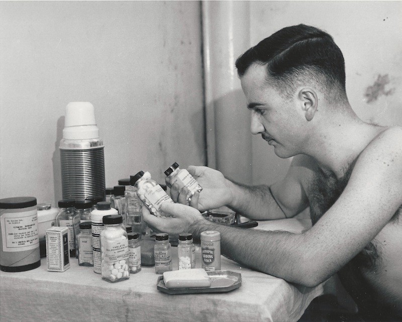 Mr. Nixon examines pill bottles in 1955.