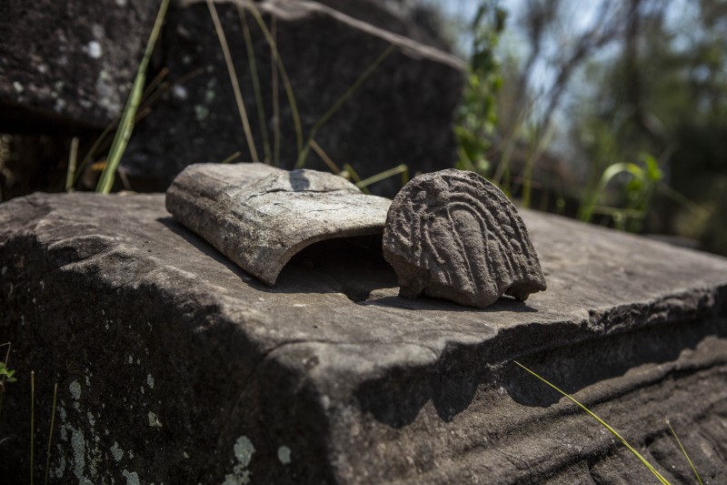 Ancient Secrets 6 A roof tile discovered last month, which archaeologists believe indicates that elite lived in the temple compound. (Enric Catala)