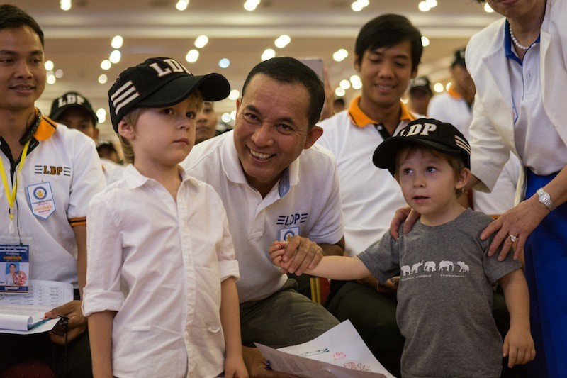 League for Democracy Party President Khem Veasna poses with young supporters at a party convention in Phnom Penh on Monday. (Hannah Hawkins/The Cambodia Daily)