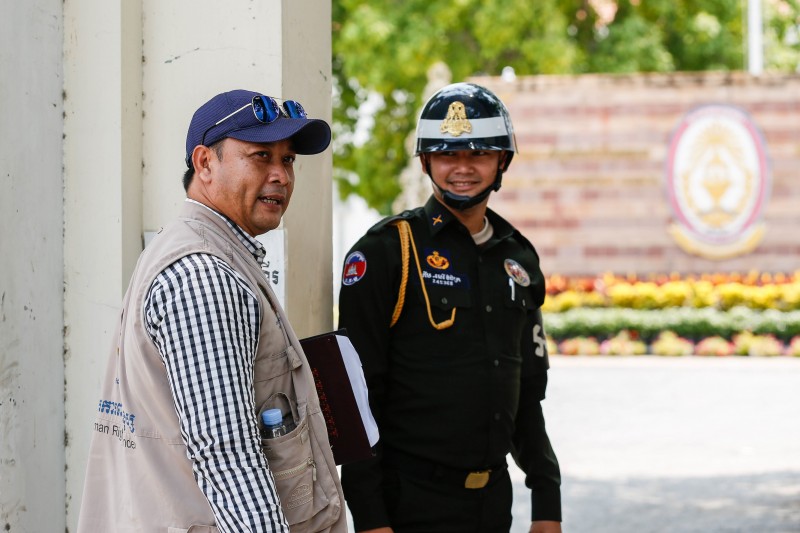 Nay Vanda, Adhoc's deputy head of monitoring, enters the Anti-Corruption Unit's headquarters in Phnom Penh on Wednesday. (Siv Channa/The Cambodia Daily)