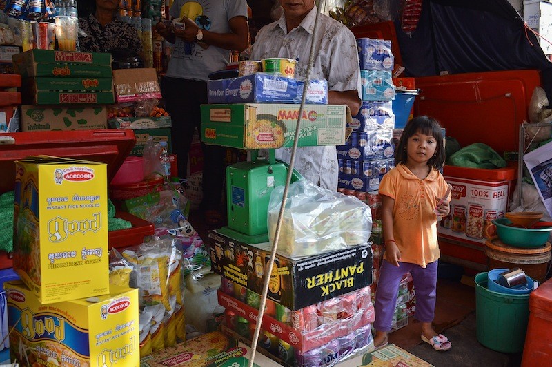 A young girl waits to purchase potato chips at a shop in Phnom Penh on Wednesday. (Ben Paviour/The Cambodia Daily)