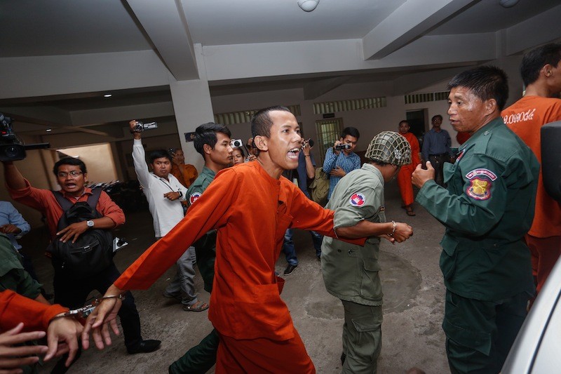 Former monk Dav Tep is escorted into the Phnom Penh Municipal Court last month to face charges of drug possession, forgery and making a death threat. (Siv Channa/The Cambodia Daily)
