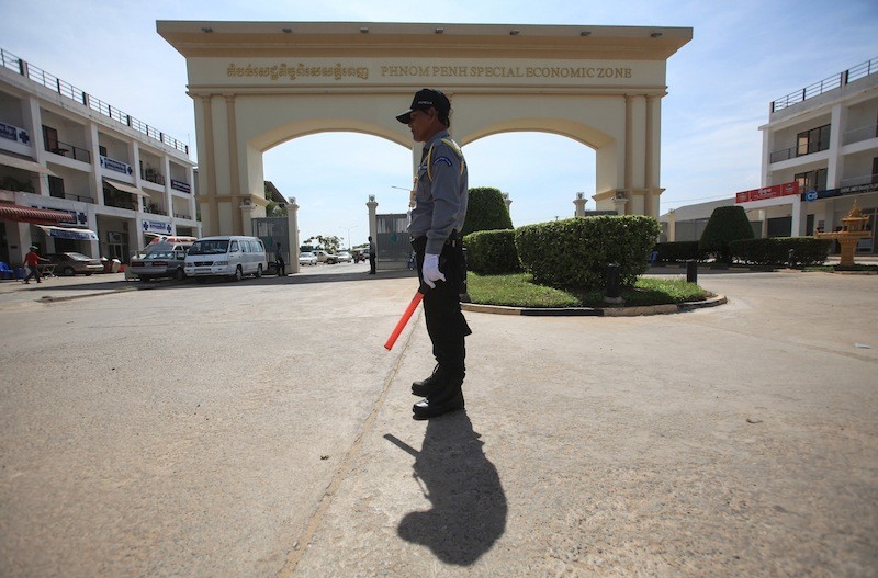 A security guard stands outside the Phnom Penh Special Economic Zone in late 2014. (Pring Samrang/Reuters)