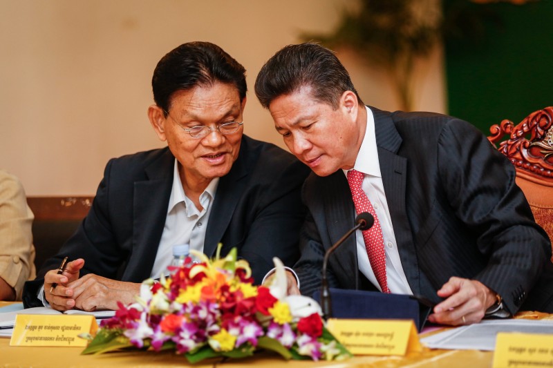 Transport Minister Sun Chanthol, right, speaks with Secretary of State Touch Chankosal during a meeting with private transport companies in Phnom Penh yesterday. (Siv Channa/The Cambodia Daily)