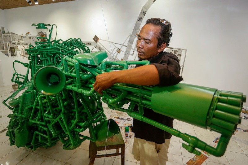 Artist Meas Sokhorn checks the final details of his installation on Tuesday. (Siv Channa/The Cambodia Daily)