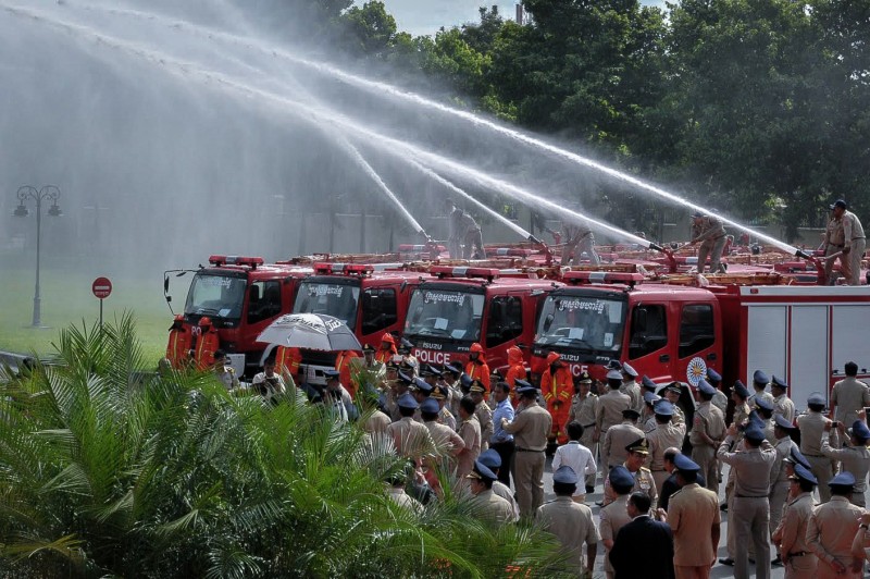 Police officers test new fire trucks purchased from China during an event at the Interior Ministry in Phnom Penh on Thursday. (Khem Sovannara)