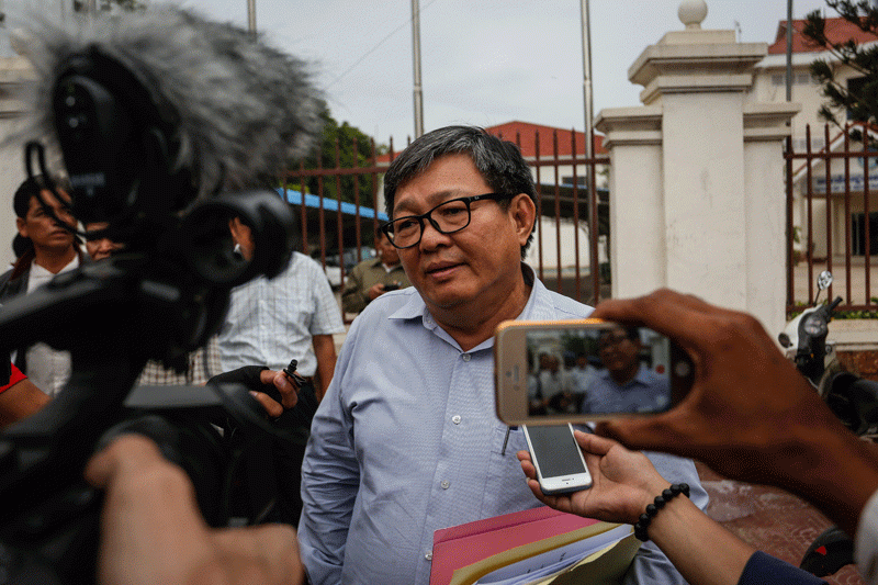CNRP lawmaker Son Chhay briefs reporters outside the party's Phnom Penh headquarters on Friday. (Siv Channa/The Cambodia Daily)
