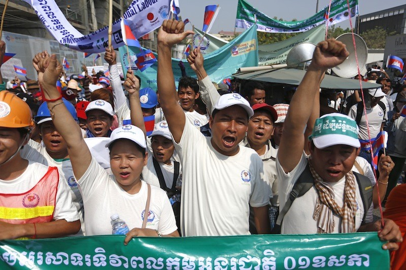 Union leader Ath Thorn, center, leads a march toward the National Assembly in Phnom Penh on Sunday to mark International Labor Day. (Siv Channa/The Cambodia Daily)