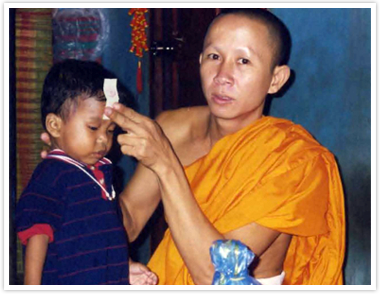 Jordan Pisey Windle is blessed by a monk in Phnom Penh before leaving to the U.S., in a picture supplied by Jerry Windle.