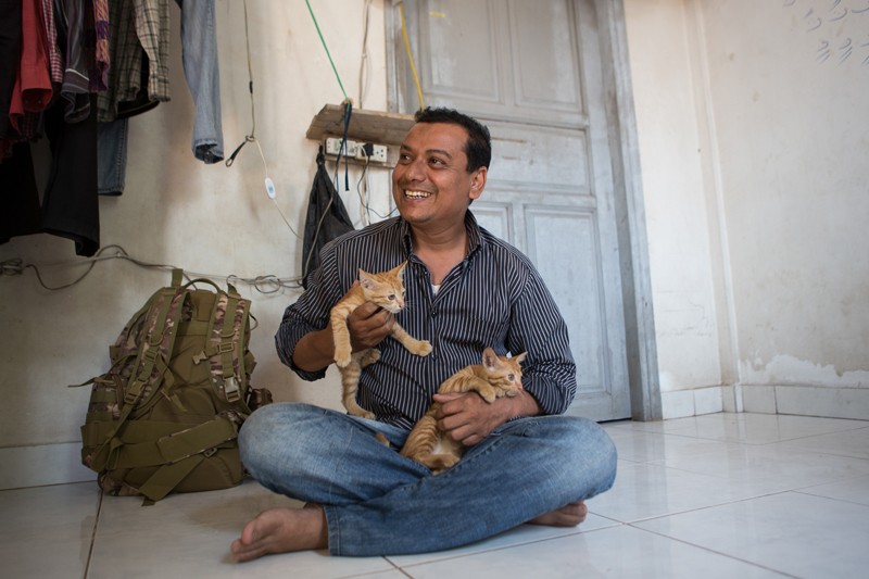 Mr. Sabirahmad holds two of his kittens. (Hannah Hawkins/The Cambodia Daily)