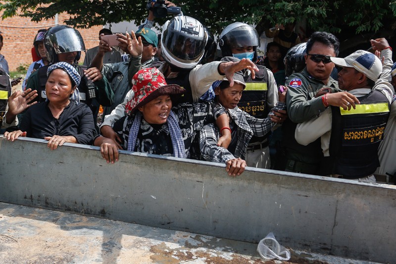 Activists attempting to join a protest outside Phnom Penh's Prey Sar prison are forced into the bed of a police truck on Monday morning. (Siv Channa/The Cambodia Daily)