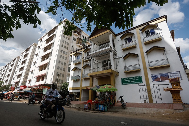 A motorist drives past the newly constructed ninth apartment building in Phnom Penh’s Borei Keila neighborhood yesterday. (Siv Channa/The Cambodia Daily) 