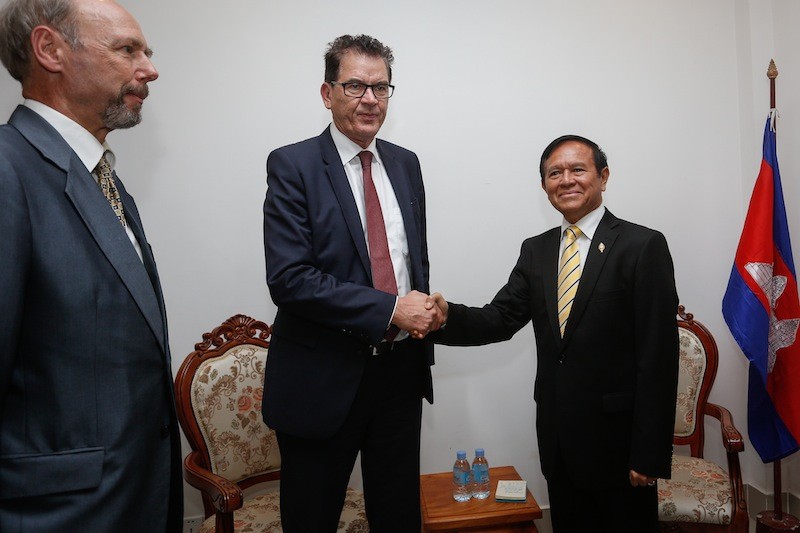 CNRP Vice President Kem Sokha, right, shakes hands with German Minister for Economic Cooperation and Development Gerd Muller at the party's headquarters in Phnom Penh on Wednesday. (Siv Channa/The Cambodia Daily) 