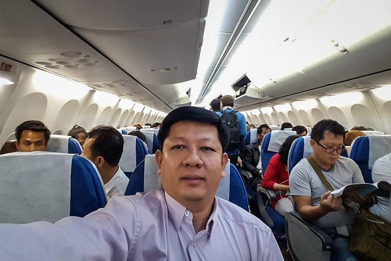 Education Ministry official Kry Seang Long takes a selfie while en route to Seoul on May 21, in a photograph posted to his Facebook account.