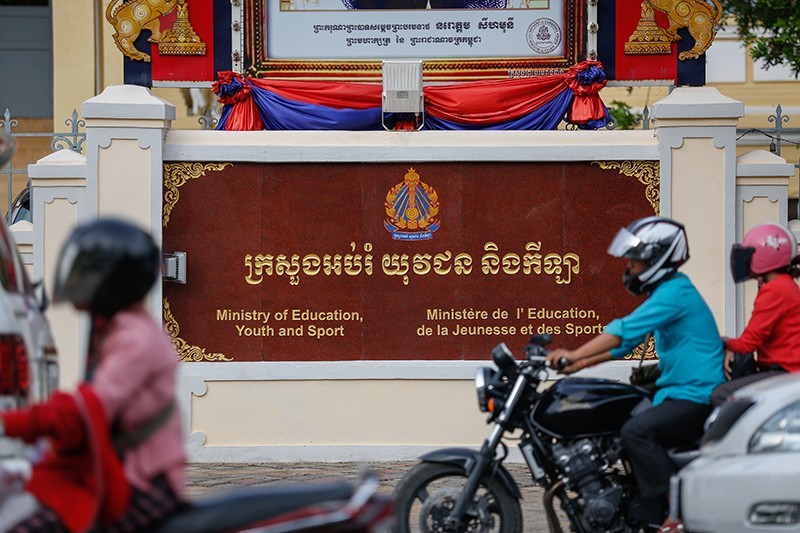 Motorists drive past the Education Ministry in Phnom Penh earlier this month. (Siv Channa/The Cambodia Daily) 