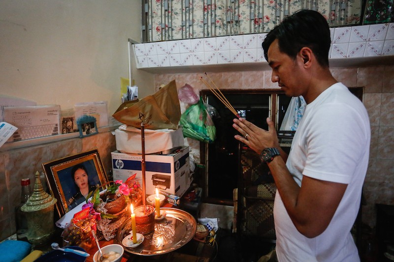 A cousin of Ly Davy prays in front of a shrine inside her home in Phnom Penh yesterday. (Siv Channa/The Cambodia Daily)