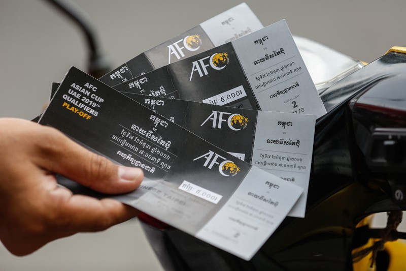 A football fan holds fake tickets for tonight's game between Cambodia and Chinese Taipei. (Siv Channa/The Cambodia Daily)