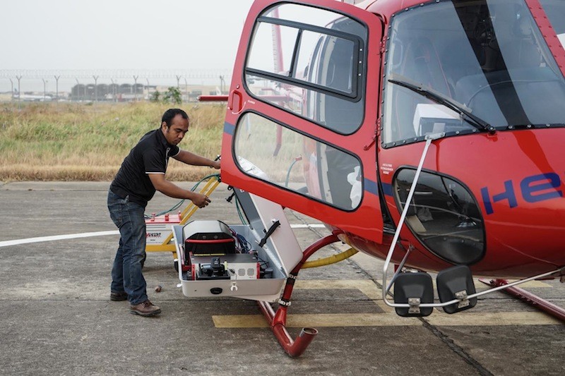 Research May Alter Accepted History of Angkor’s End 1 A man inspects lidar equipment mounted on the right skid of a helicopter in 2015 (Francisco Goncalves)