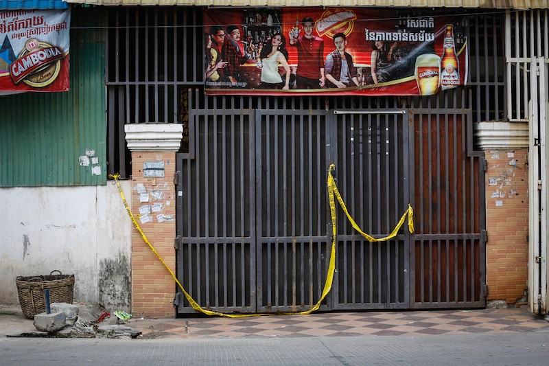 Police tape hangs across the door of the Samnang La'or massage parlor on Street 430 in Phnom Penh's Chamkar Mon district on Tuesday. (Siv Channa/The Cambodia Daily)