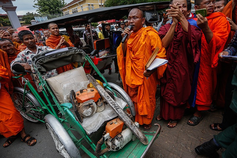 But Buntenh speaks outside the Forestry Administration's headquarters in Phnom Penh last year as other monks display chainsaws seized from illegal loggers in the Prey Lang forest. (Siv Channa/The Cambodia Daily) 