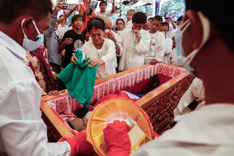 Kem Ley's widow, Bou Rachana, blesses her late husband's body during a burial ceremony in Takeo province last month. (Siv Channa/The Cambodia Daily)