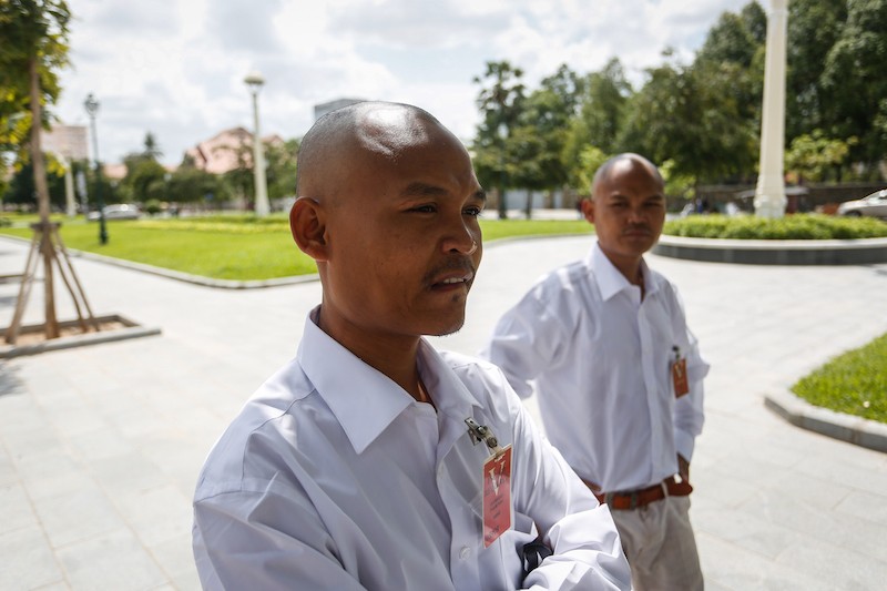 Brothers Chum Huot and Chum Huor wait outside the US Embassy in Phnom Penh on Wednesday for what they said was a meeting about Kem Ley's murder. (Siv Channa/The Cambodia Daily)