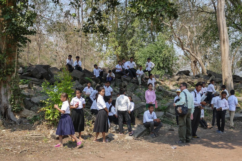 Students relax before the start of a heritage education session at the Banteay Chhmar monument in February. (Olivier Cunin)