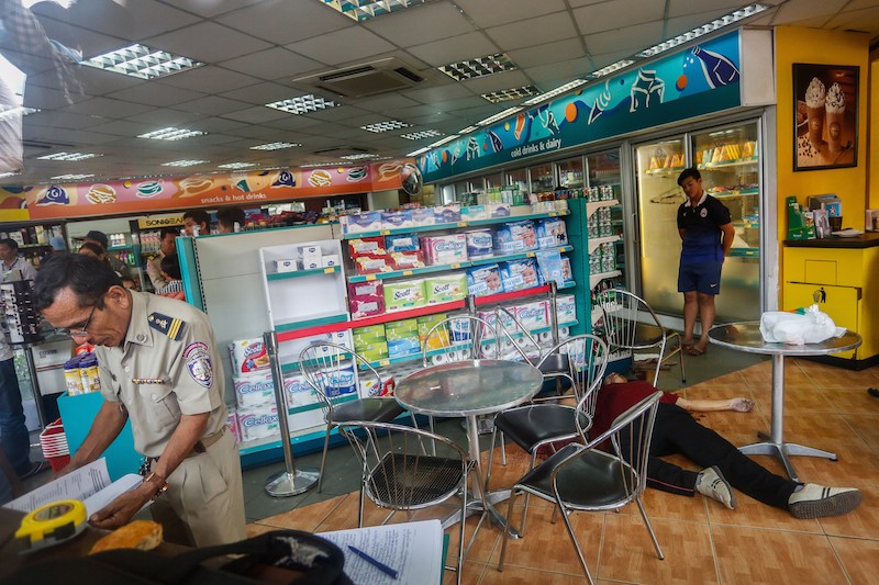 Kem Ley's body lies on the floor of a gas station convenience store in Phnom Penh after he was shot dead on the morning of July 10. (Siv Channa/The Cambodia Daily)
