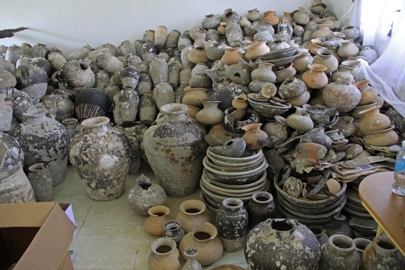 Pots and other ceramics recovered from the Koh Sdech shipwreck sit in a storeroom at the Koh Kong Provincial Court in 2013. (Nancy Beavan)