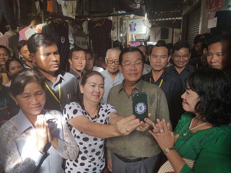 Prime Minister Hun Sen poses for a selfie at a market in a photo posted to his Facebook page last week.