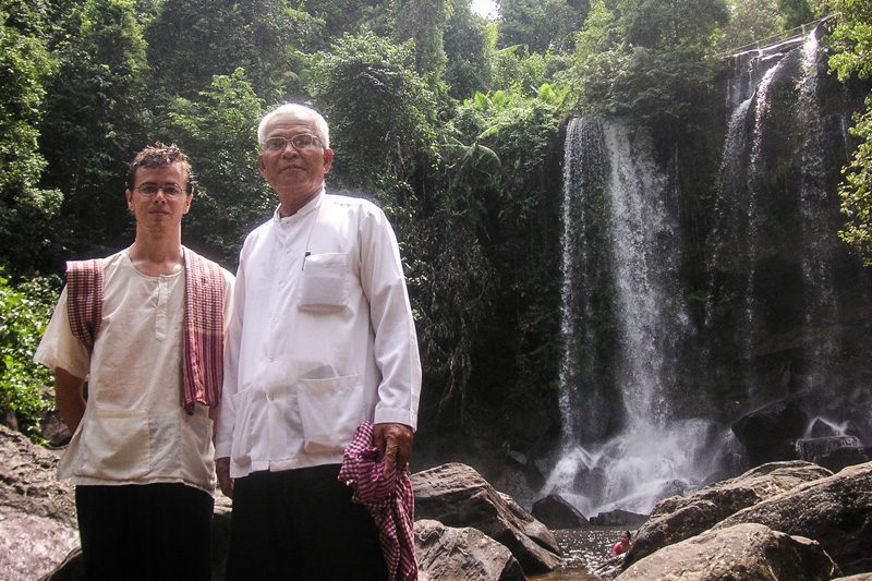 Trent Walker and Prum Ut pose near a waterfall in Siem Reap province in 2006. (Trent Walker)