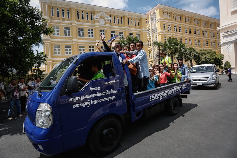 ABC radio owner Seng Bunveng and his supporters leave Phnom Penh City Hall on Tuesday in the bed of a new truck donated to the station by Prime Minister Hun Sen. (Siv Channa/ The Cambodia Daily)