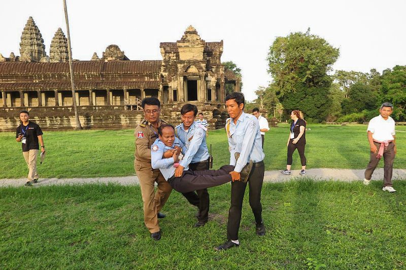 A police officer and two Apsara Authority officials carry a man during a first aid drill at Angkor Wat in Siem Reap province last week. (Apsara Authority)