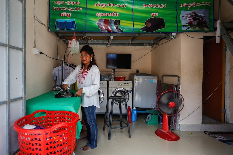 Chray Nim works inside her laundry in Phnom Penh's Tuol Kok district on Monday. (Siv Channa/The Cambodia Daily)