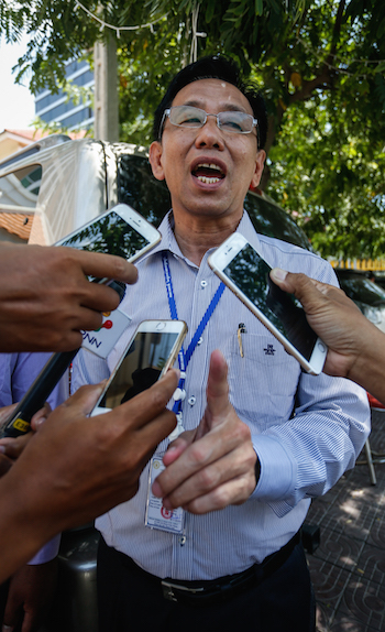 Attorney Ky Tech speaks to reporters after filing lawsuits on behalf of Prime Minister Hun Sen against opposition Senator Thak Lany and opposition leader Sam Rainsy at the Phnom Penh Municipal Court on Monday. (Siv Channa/The Cambodia Daily)