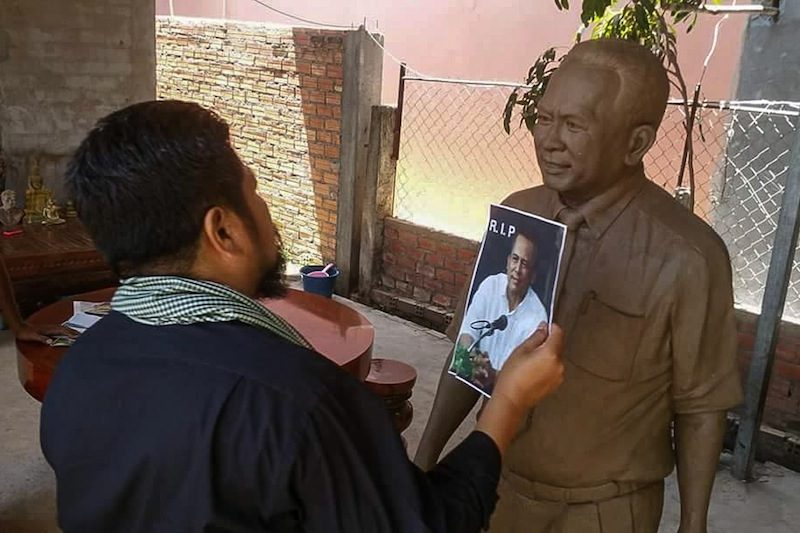 Opposition lawmaker Ou Chanrath inspects a statue of slain political analyst Kem Ley, in a photograph posted to his Facebook page.