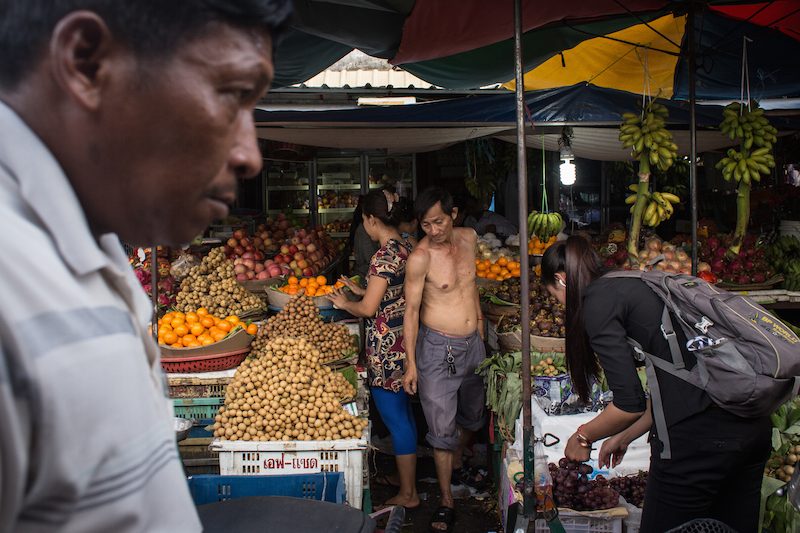 Buyers peruse fruit stands at Phsar Kandal market in Phnom Penh on Tuesday afternoon. (Hannah Hawkins/The Cambodia Daily)