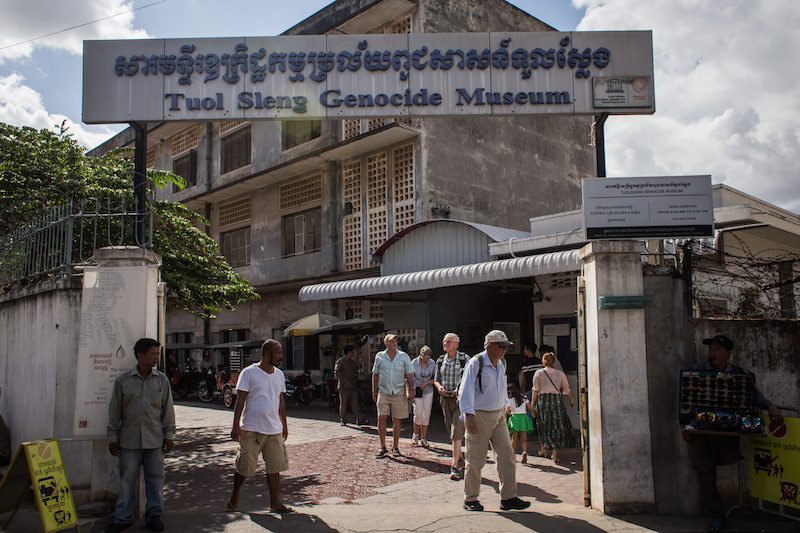 Tourists leave the Tuol Sleng Genocide Museum in Phnom Penh yesterday afternoon. (Hannah Hawkins/The Cambodia Daily)