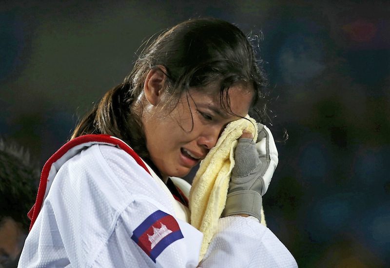 Cambodian taekwondo star Sorn Seavmey, left, cries after losing to Reshmie Oogink from the Netherlands in the preliminary round of the women’s over 67 kg competition at the Olympic Games in Rio de Janeiro on Saturday. (Reuters) 