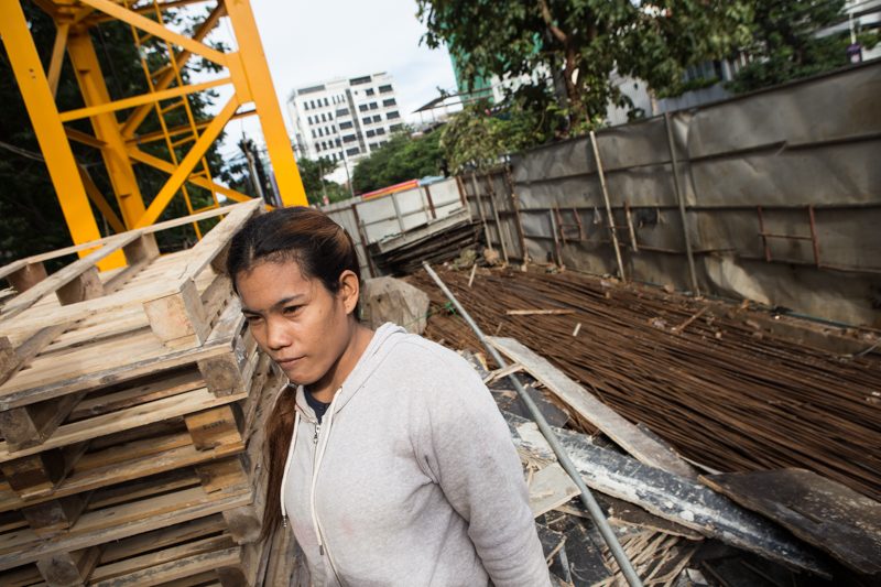 A worker stands inside a construction site on the corner of streets 214 and 63. (Hannah Hawkins/The Cambodia Daily)