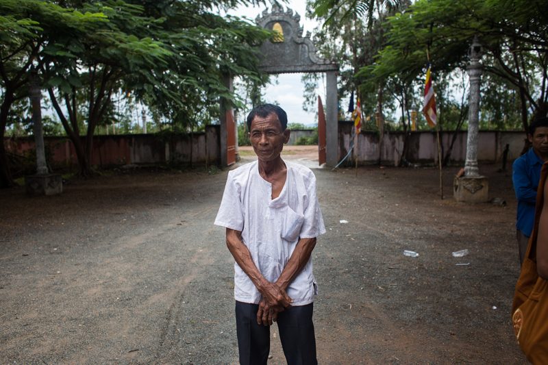 A pagoda priest stands near the entrance of Wat Preah Damboukbon. (Hannah Hawkins/The Cambodia Daily)