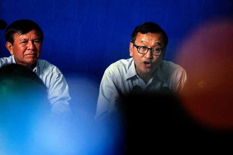 Opposition CNRP leader Sam Rainsy and deputy leader Kem Sokha speak at an event. (Siv Channa/The Cambodia Daily)