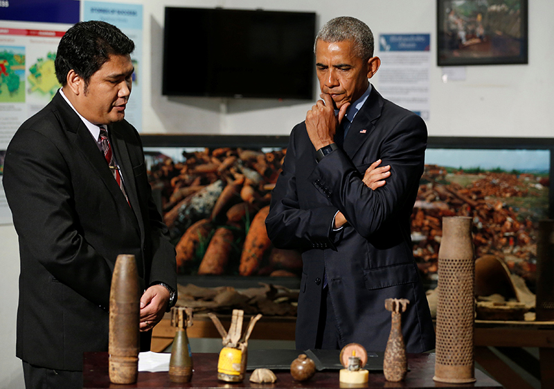 US President Barack Obama, right, looks at old ordnance in Vientiane on Wednesday. (Reuters)