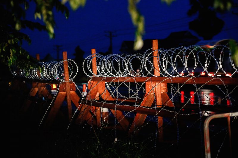 A razor-wire barricade sits on the side of National Road 6 in Kandal province, where police are planning to set up checkpoints across roads leading to Phnom Penh ahead of a planned opposition gathering to coincide with the trial of CNRP Vice President Kem Sokha on Friday. (Siv Channa/The Cambodia Daily) 