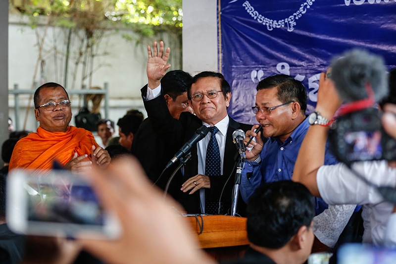 Deputy opposition leader Kem Sokha waves to supporters at the CNRP’s headquarters in Phnom Penh on Friday. (Siv Channa/The Cambodia Daily)