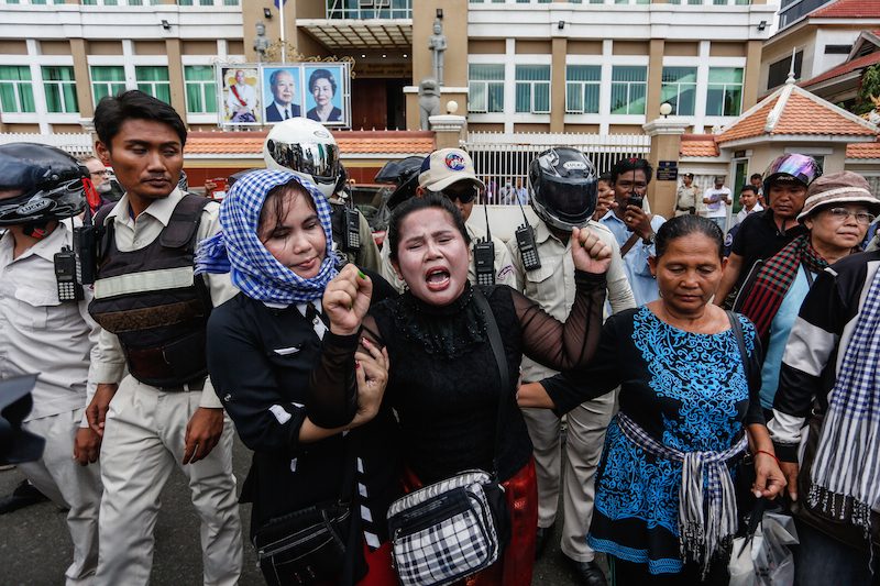 Activist Bo Chhorvy, center, shouts outside the Phnom Penh Municipal Court on Monday morning after being sentenced to six months in prison. (Siv Channa/The Cambodia Daily) 