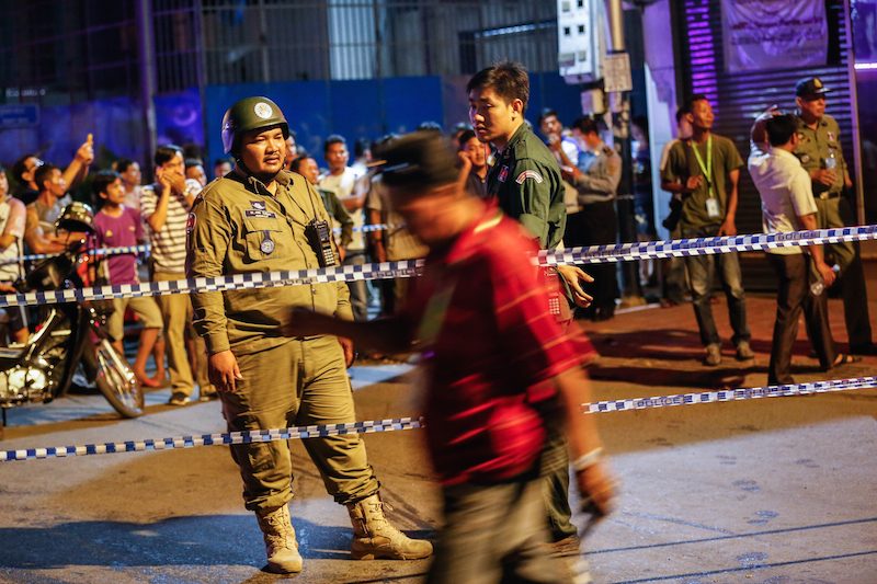 Police guard the scene of a grenade blast in Phnom Penh on Tuesday night. (Siv Channa/The Cambodia Daily)