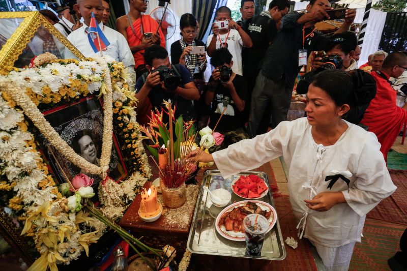 Bou Rachana, the widow of slain political analyst Kem Ley, places incense at her husband’s shrine during his funeral in July. (Siv Channa/The Cambodia Daily)